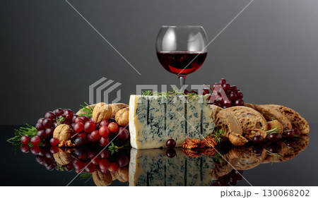 Gorgonzola cheese with ciabatta, walnuts, grapes, and red wine. Gorgonzola cheese with ciabatta, walnuts, grapes, and red wine. 130068202