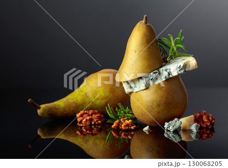 Blue cheese with pear, walnuts, and rosemary. 130068205