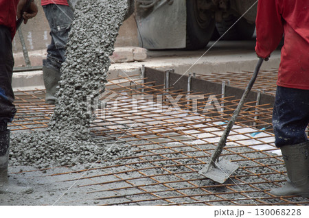 Workers are pouring concrete and cement at the construction site. Workers are pouring concrete and cement at the construction site. 130068228