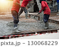 Workers are pouring concrete and cement at the construction site. 130068229