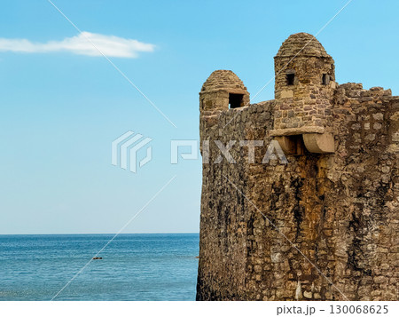 Fortress walls standing by the sea with church tower in Montenegro, Budva. Architecture, history, and cultural heritage in coastal landscape. Fortress walls standing by the sea with church tower in Montenegro, Budva. Architecture, history, and cultural heritage in coastal landscape. 130068625