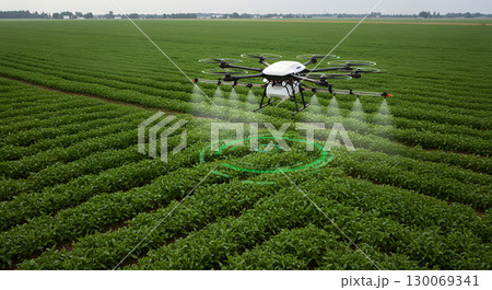 Agricultural drone spraying crops in green field with technology precision 130069341