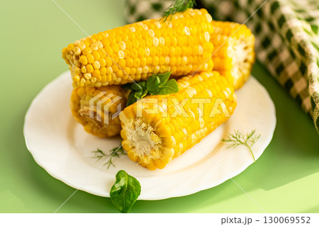 Golden corn kernels close-up on a green background 130069552