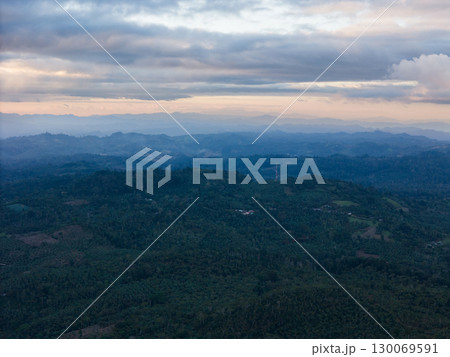 Scenic view of rolling hills and valleys under cloudy sky at dusk 130069591