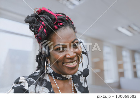 African American customer service representative with headset providing technical support 130069682