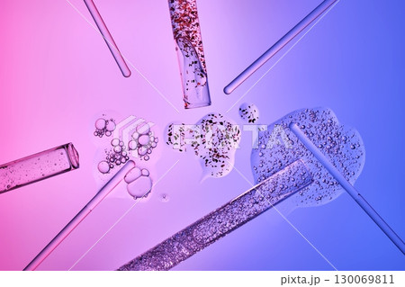 Test tubes with serums and various scientific laboratory supplies on a blue-purple background. Test tubes with serums and various scientific laboratory supplies on a blue-purple background. 130069811