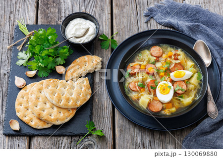 Polish sauerkraut soup with sausage in a bowl Polish sauerkraut soup with sausage in a bowl 130069880