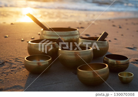 Singing Bowls on Beach at sunrise. Singing Bowls on Beach at sunrise. 130070308