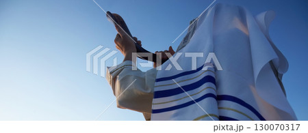 Jewish man blowing the Shofar horn of Rosh Hashanah - New Year. 130070317