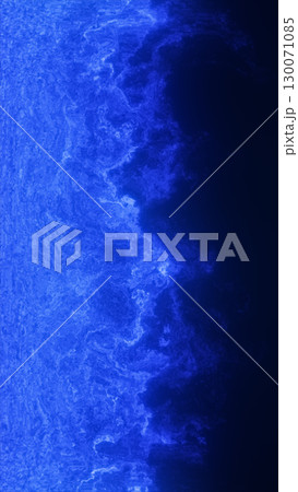 Deep blue abstract texture mimics a glowing coastline or electric wave crashing in darkness 130071085