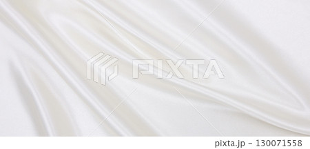 Smooth elegant white silk or satin luxury cloth texture as wedding background. Luxurious background design Smooth elegant white silk or satin luxury cloth texture as wedding background. Luxurious background design 130071558