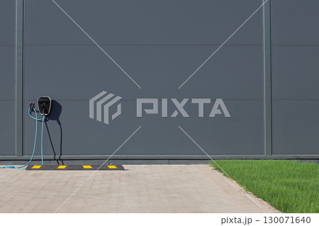 Electric vehicle charging point at parking space Electric vehicle charging point at parking space 130071640