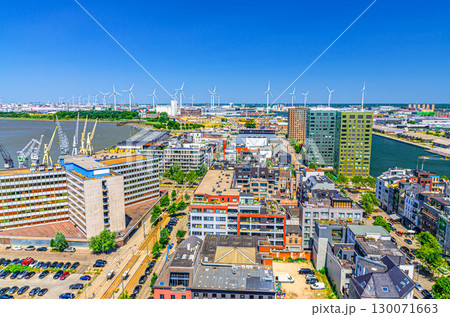 Antwerp cityscape, aerial panoramic view of Antwerp city Eilandje quarter neighborhood with port area, water canals, windmills on skyline horizon, panorama of Antwerpen, Flemish Region, Belgium Antwerp cityscape, aerial panoramic view of Antwerp city Eilandje quarter neighborhood with port area, water canals, windmills on skyline horizon, panorama of Antwerpen, Flemish Region, Belgium 130071663