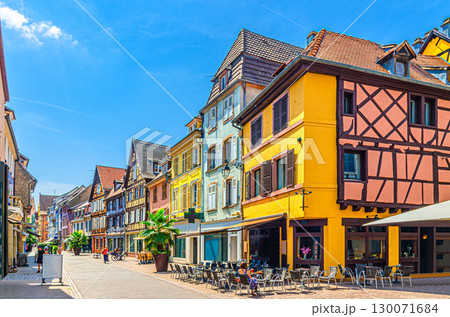 Old houses colorful facade, medieval buildings with colorful walls, shutters windows, street restaurant on pedestrian street in old town Colmar city historic centre, Alsace Grand Est region, France 130071684