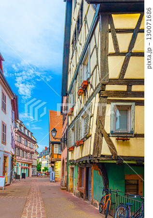 Old houses medieval buildings with half-timbered style facades with colorful walls, shutters windows on narrow street in old town Colmar city historic centre, Alsace Grand Est region, France Old houses medieval buildings with half-timbered style facades with colorful walls, shutters windows on narrow street in old town Colmar city historic centre, Alsace Grand Est region, France 130071686
