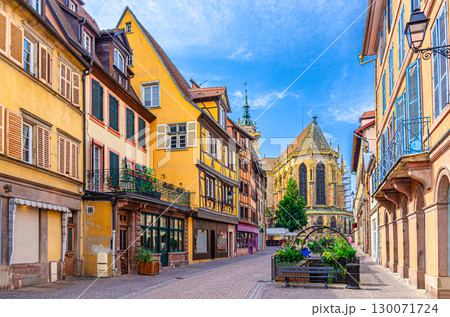 Old houses half-timbered colorful facade, medieval buildings shutters windows on Rue de Eglise street, Saint-Martin church in old town Colmar city historic centre, Alsace Grand Est region, France 130071724