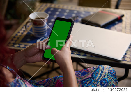 Woman Using Smartphone with Green Screen at Outdoor Workspace Woman Using Smartphone with Green Screen at Outdoor Workspace 130072021