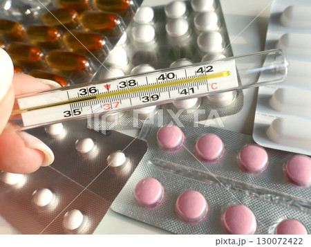 Close-Up of Medical Pills and Selected Thermometer Showing Body Temperature Close-Up of Medical Pills and Selected Thermometer Showing Body Temperature 130072422
