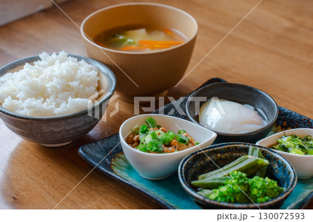 ご飯と味噌汁に納豆や温泉卵、野菜の小鉢を添えた和風朝食セット 130072593