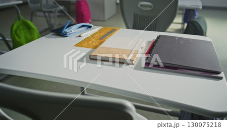 Close Up Shot of School Desk with Student School Supplies: Pencil Case, Pens and Pencils, Notebooks Close Up Shot of School Desk with Student School Supplies: Pencil Case, Pens and Pencils, Notebooks 130075218
