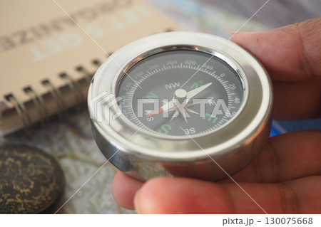 Exploring with a compass in hand during a sunny afternoon Exploring with a compass in hand during a sunny afternoon 130075668