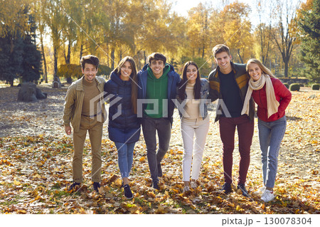 Group portrait of happy friends walking in autumn park Group portrait of happy friends walking in autumn park 130078304