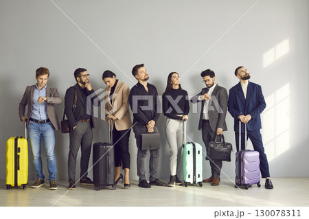 Business people waiting in line at the check-in counters or boarding gate at the airport Business people waiting in line at the check-in counters or boarding gate at the airport 130078311