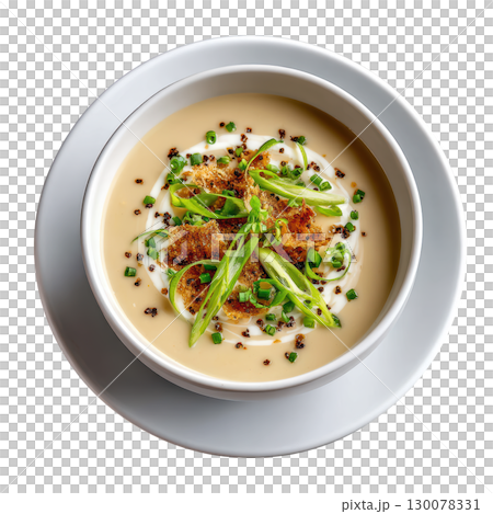 Creamy Leek and Potato Veloute Soup Served with Leek Ash Crisps and Chive Cream in Shallow Bowl 130078331