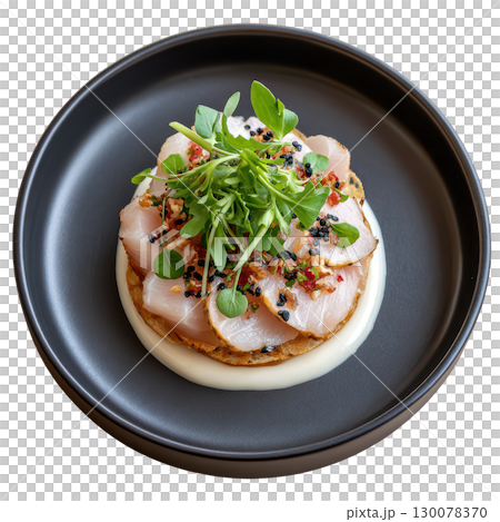 Delicate Amberjack Sashimi with Yuzu Truffle Dressing and Micro Yuzu Leaves Artfully Arranged on a Plate 130078370