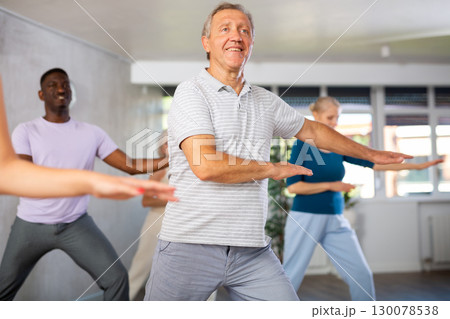 Mature men and women practicing Hip-hop dance in training hall Mature men and women practicing Hip-hop dance in training hall 130078538