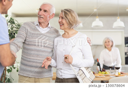 Couple of elderly man and woman greeting friends Couple of elderly man and woman greeting friends 130078604
