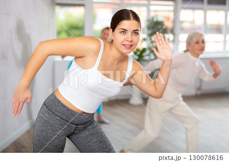 Different ages women learning swing steps at dance class 130078616
