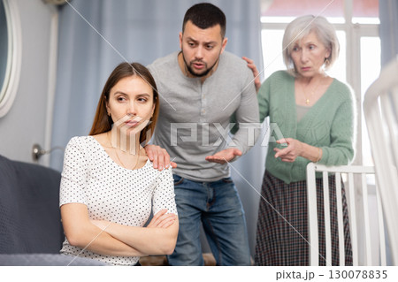 Depressed young woman during conflict with family at home Depressed young woman during conflict with family at home 130078835