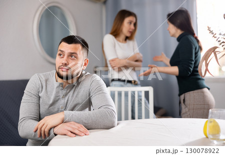 Man waiting for two women stop quarreling 130078922