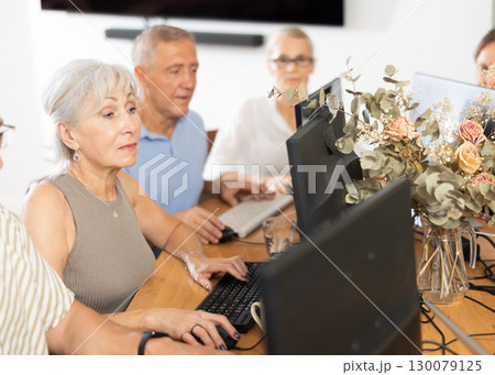 Group of older people studying on computer course Group of older people studying on computer course 130079125