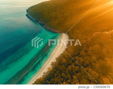 Stunning view of a serene beach at sunset by the tranquil turquoise waters of a coastal area 130080670