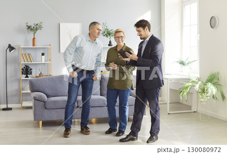 Real Estate Agent Showing New Home To Senior Couple 130080972