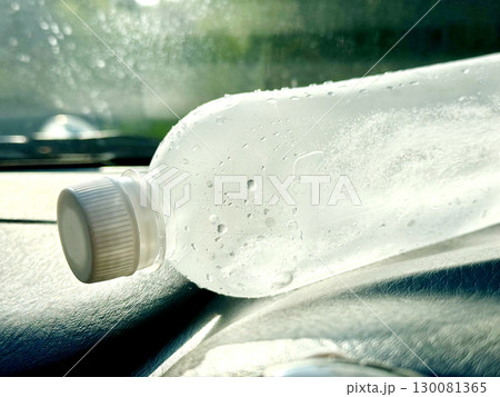 車のダッシュボードに置かれた冷たい水の入ったペットボトル 130081365