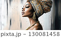 Portrait of an elegant African woman adorned with traditional accessories and a beautiful head wrap 130081458