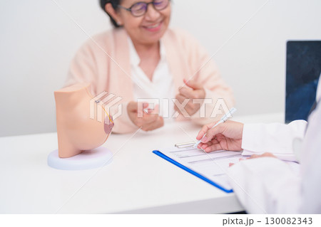 Elderly woman Patient consultation with doctor for Breast Augmentation Surgery, October Breast Cancer Awareness month, implant, Diagnosis, Beauty woman enlargement and medical healthcare concept 130082343