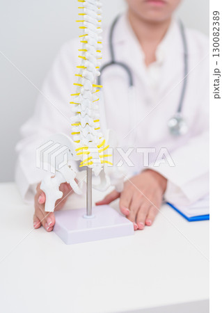 Elderly Patient consulting Doctor with Spine anatomy for Spinal Cord Disorder and disease, Back pain, Lumbar, Sacral pelvis, Cervical neck, Thoracic, Coccyx, Orthopedist, chiropractic, Office Syndrome 130082389