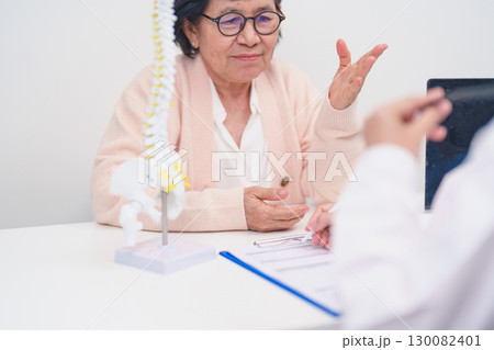 Elderly Patient consulting Doctor with Spine anatomy for Spinal Cord Disorder and disease, Back pain, Lumbar, Sacral pelvis, Cervical neck, Thoracic, Coccyx, Orthopedist, chiropractic, Office Syndrome Elderly Patient consulting Doctor with Spine anatomy for Spinal Cord Disorder and disease, Back pain, Lumbar, Sacral pelvis, Cervical neck, Thoracic, Coccyx, Orthopedist, chiropractic, Office Syndrome 130082401