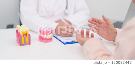 Elderly Patient consulting Dentist to Tooth disease, Senior Health Medical Diagnosis. Anatomy teeth model for Oral Teeth decay, Scrape off tartar. March Oral health, Dentist Day, False Teeth concept Elderly Patient consulting Dentist to Tooth disease, Senior Health Medical Diagnosis. Anatomy teeth model for Oral Teeth decay, Scrape off tartar. March Oral health, Dentist Day, False Teeth concept 130082449