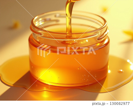 Creative Studio Pouring Fresh Natural Honey into Glass Jar Still Life 130082977