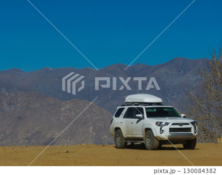 Driving off road car in high altitude mountains in tibet, China 130084382