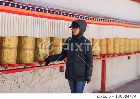 One Tibetan lady Spin the Tibetan Prayer Wheels in Potala place,Lhasa,China 130084474
