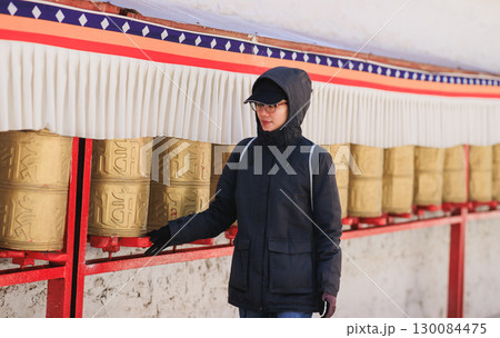 One Tibetan lady Spin the Tibetan Prayer Wheels in Potala place,Lhasa,China 130084475