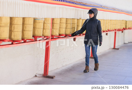 One Tibetan lady Spin the Tibetan Prayer Wheels in Potala place,Lhasa,China One Tibetan lady Spin the Tibetan Prayer Wheels in Potala place,Lhasa,China 130084476