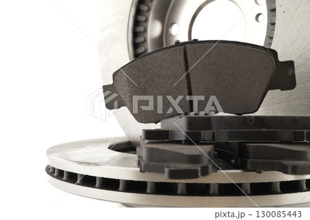 Detailed view of car brake rotor and pads, perfect for automotive repair and maintenance. 130085443
