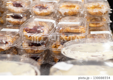 スーパーでプラスチック容器にパック詰めされたデニッシュが陳列販売される 130086554